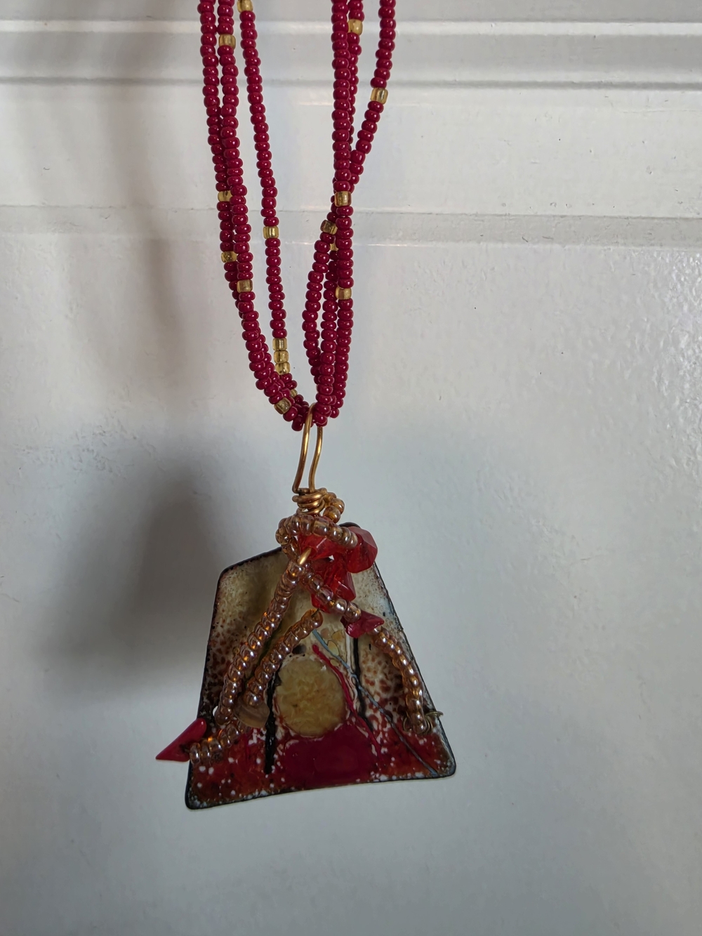 Handcrafted Red Glass Pendant Necklace with Gold Accents piece of art